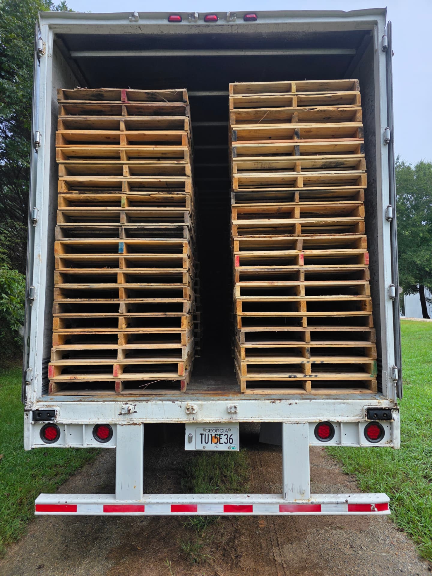 Trailer loaded with recycled pallets for a customer program